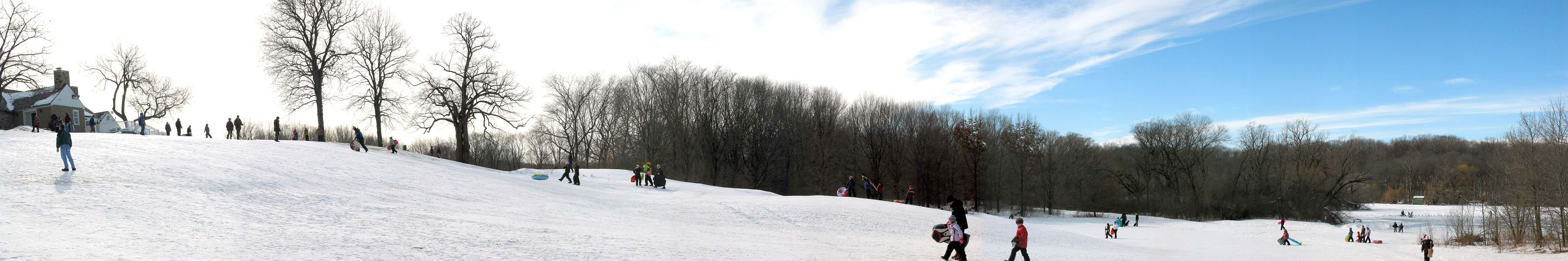 Sledding at Whitnal County Park clubhouse on a sunny day